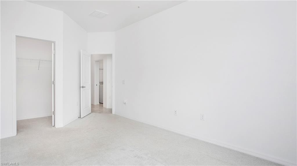 Carpeted room with white walls, baseboards, and two doorways
