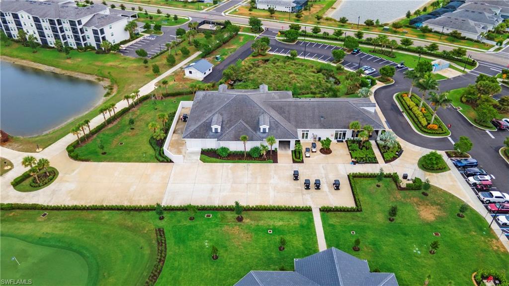 Clubhouse building featuring a gray shingle roof and white exterior siding