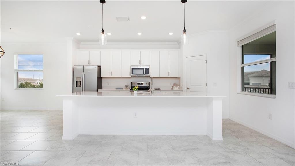 Kitchen featuring a spacious island, white cabinetry, stainless steel appliances, recessed lighting, and tile flooring