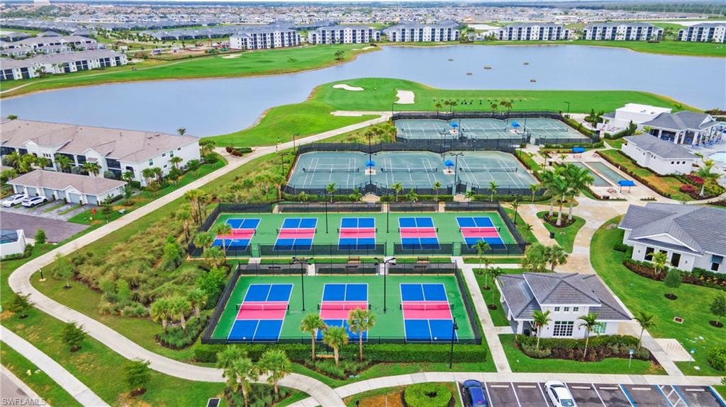 Community amenities featuring multiple tennis courts, pickleball courts, bocce ball court, a clubhouse, and a lake with surrounding golf course