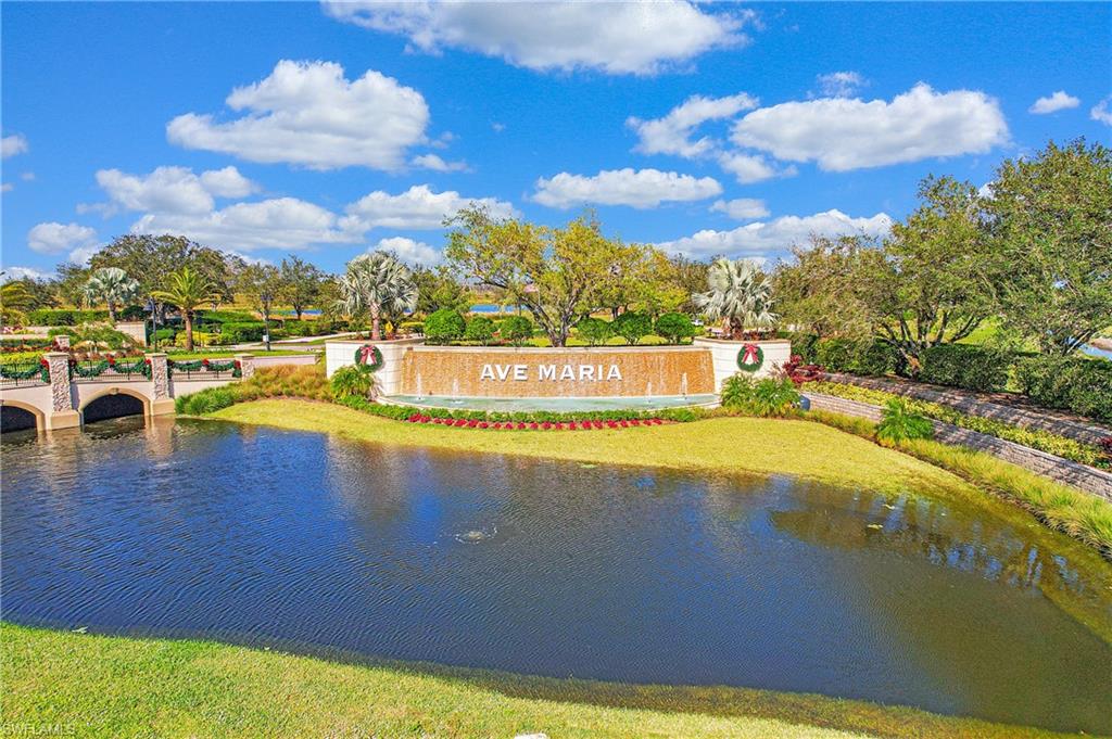 Entry monument with water feature, mature trees, and landscaped grounds