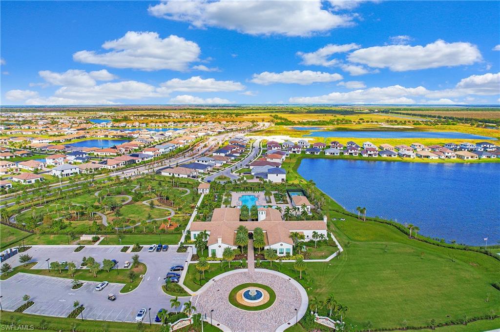 Expansive aerial rendering a residential community with numerous homes, multiple lakes, and extensive green spaces
