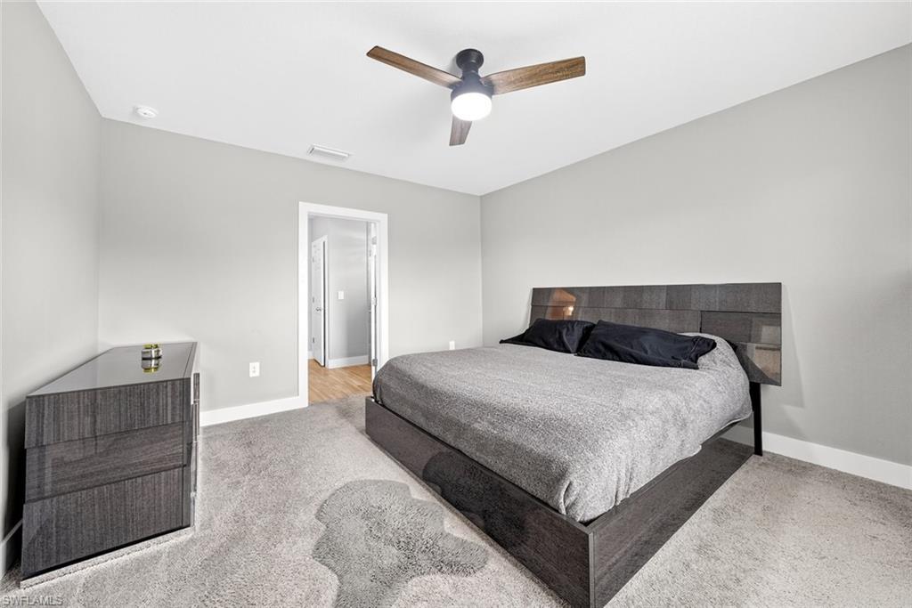 Bedroom featuring ceiling fan and light carpet