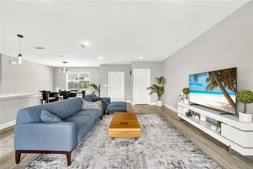 Living area featuring wood finish floors and recessed lighting
