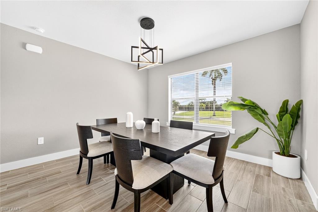 Dining area with wood tiled floors and a chandelier