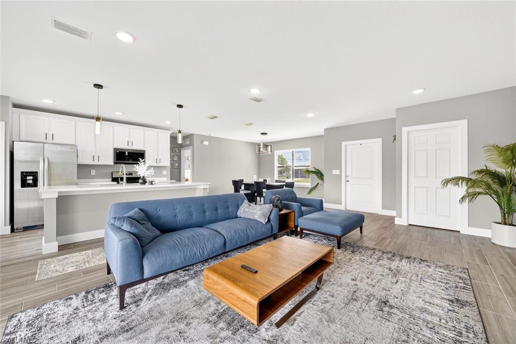 Living area with wood tiled floors and recessed lighting