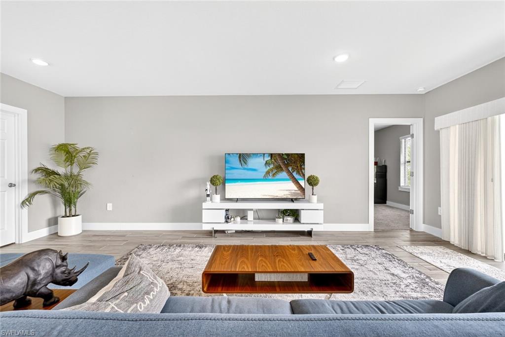 Living room with wood finished floors and recessed lighting