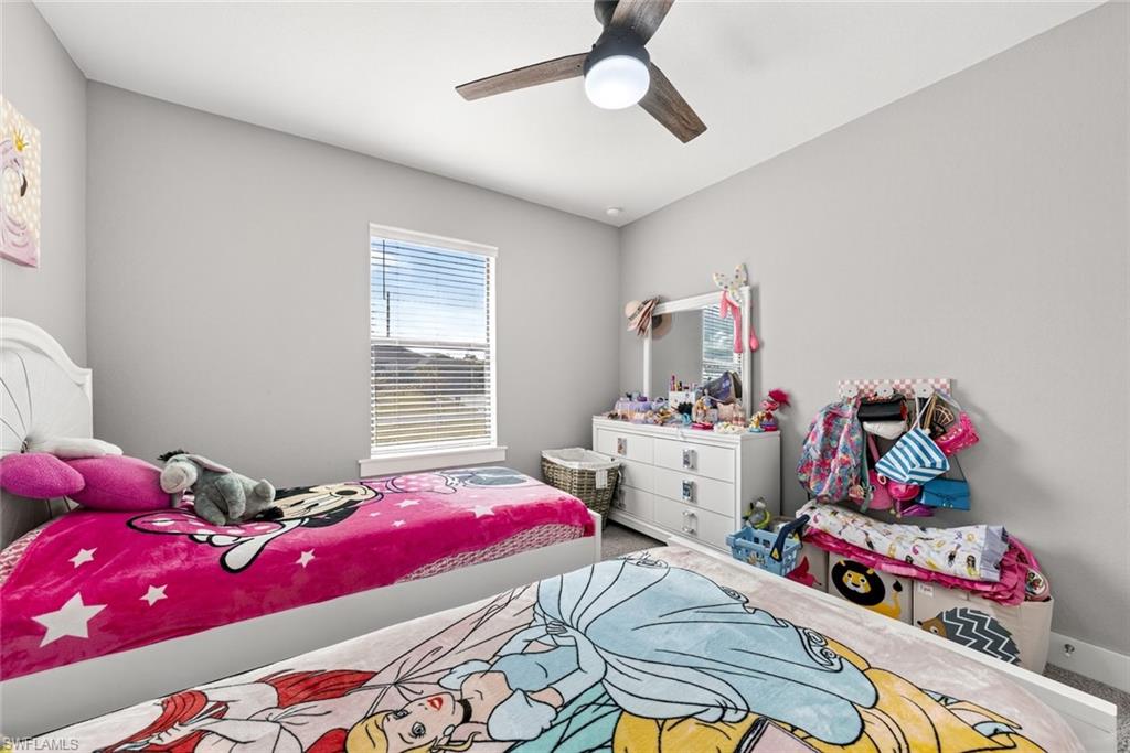 Bedroom with ceiling fan and carpet