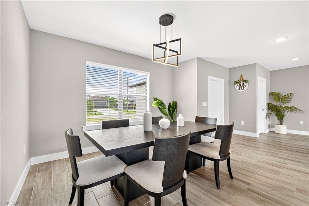 Dining room featuring wood tiled floors and baseboards