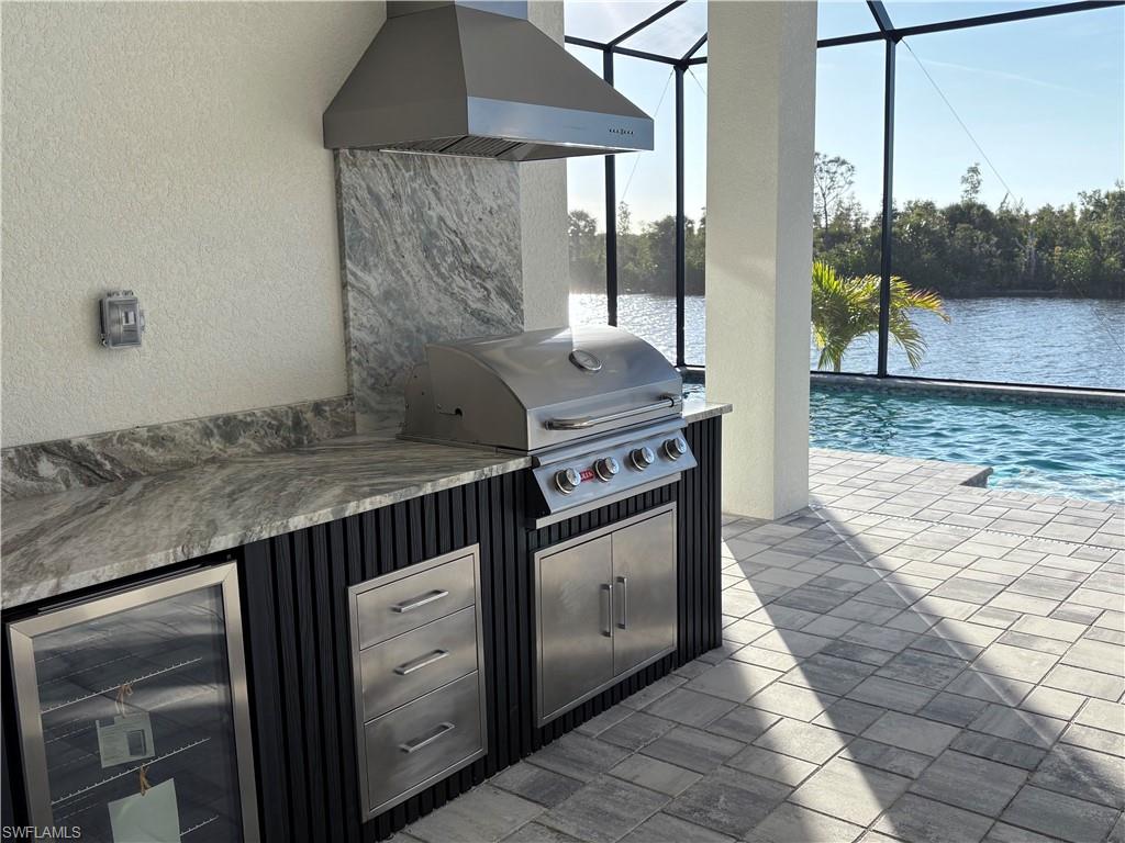View of pool featuring ceiling fan, a lanai, a patio, and an in ground hot tub