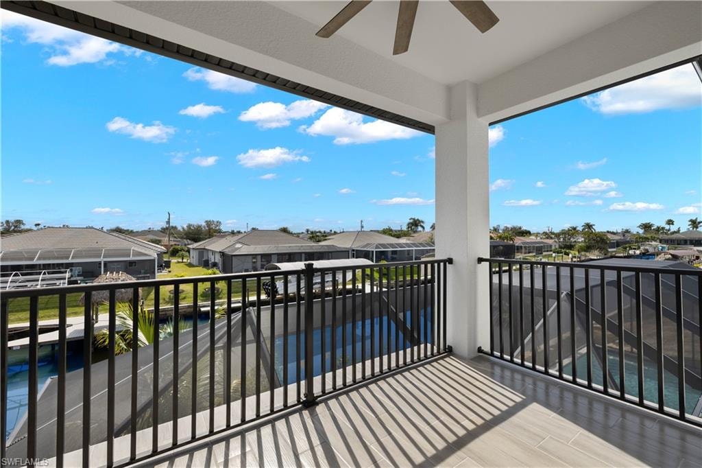 View of patio with ceiling fan, a lanai, and a pool with hot tub