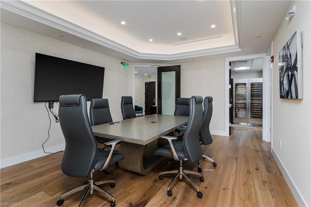 Conference room featuring wood-finish flooring, recessed lighting, and crown molding