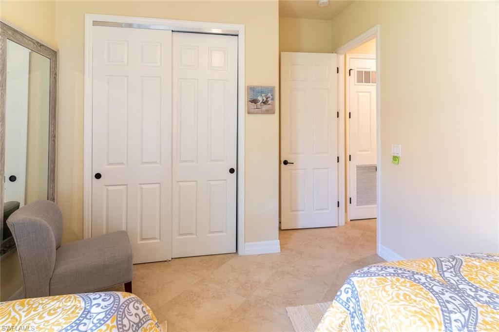 Tiled bedroom featuring a closet