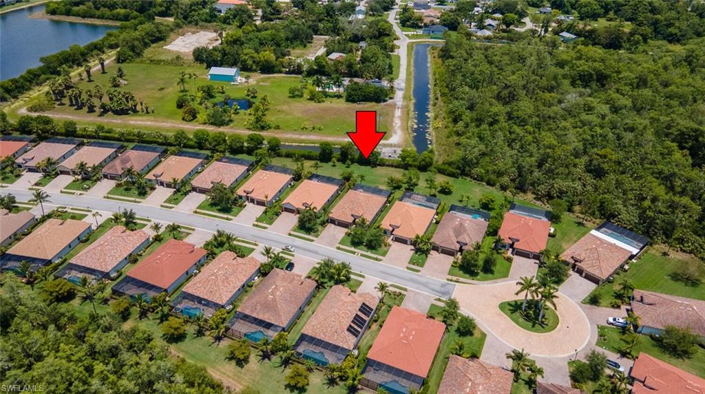 Birds eye view of property with a water view