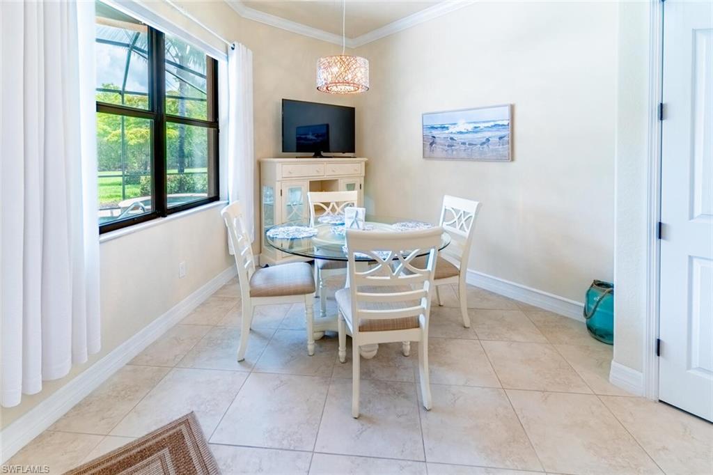 Tiled dining space featuring ornamental molding