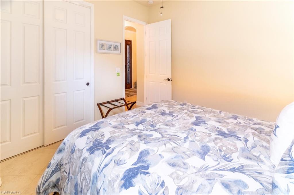 Tiled bedroom featuring a closet