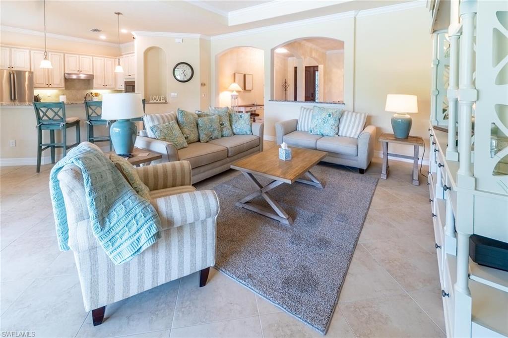 Tiled living room featuring ornamental molding