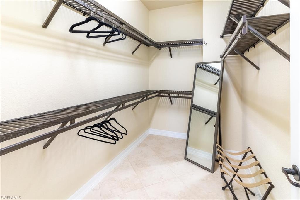 Walk in closet with tile patterned floors