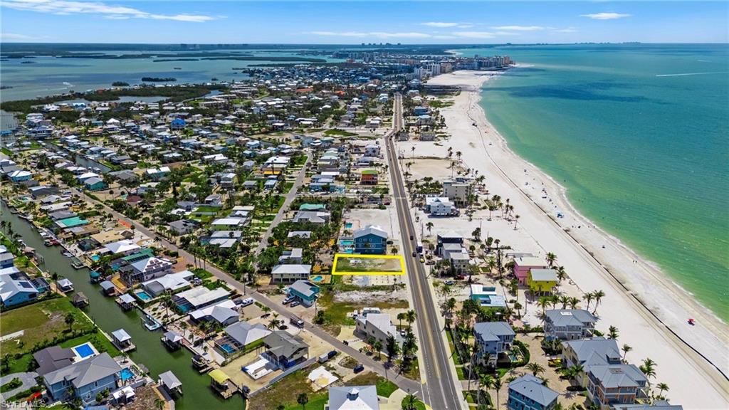 Birds eye view of property with a water view and a beach view  - Virtually Edited Image