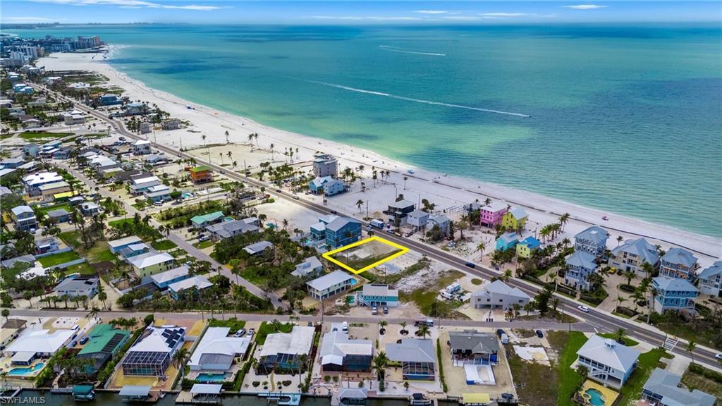 Cant beat this location, Aerial view with a water view, a residential view, and a view of the beach  - Virtually Edited Image