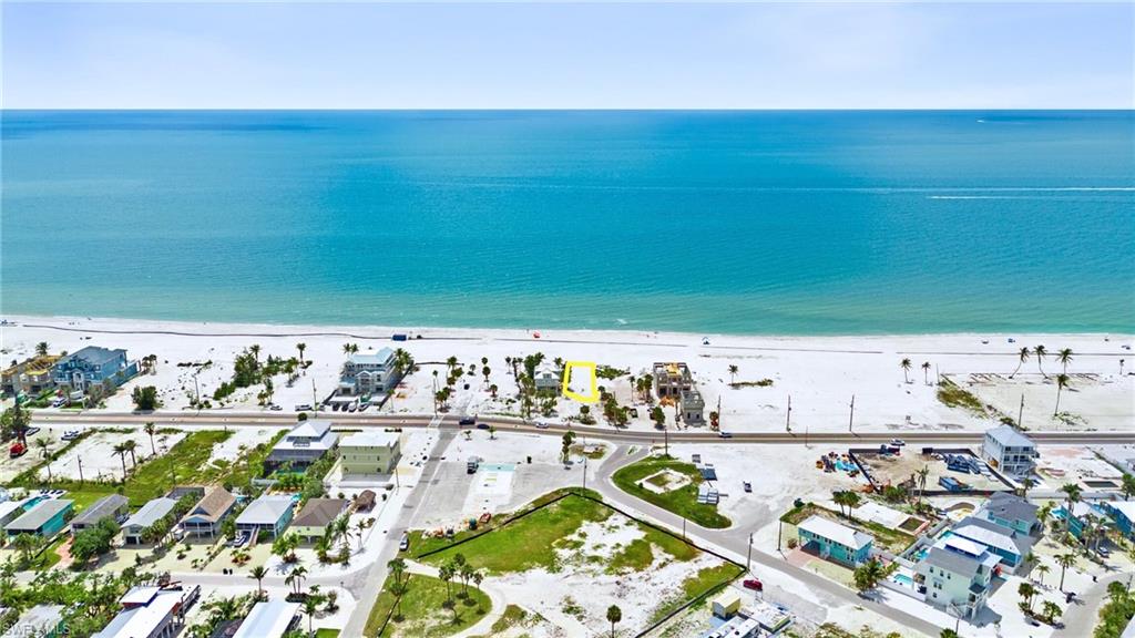 Drone / aerial view with a water view and a view of the beach  - Virtually Edited Image
