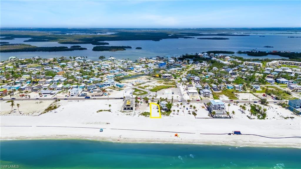 Drone / aerial view with a water view, a beach view, and a residential view  - Virtually Edited Image