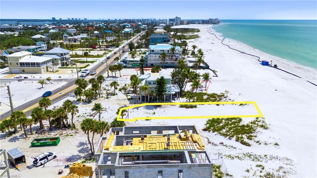 Drone / aerial view featuring a view of the beach and a water view  - Virtually Edited Image