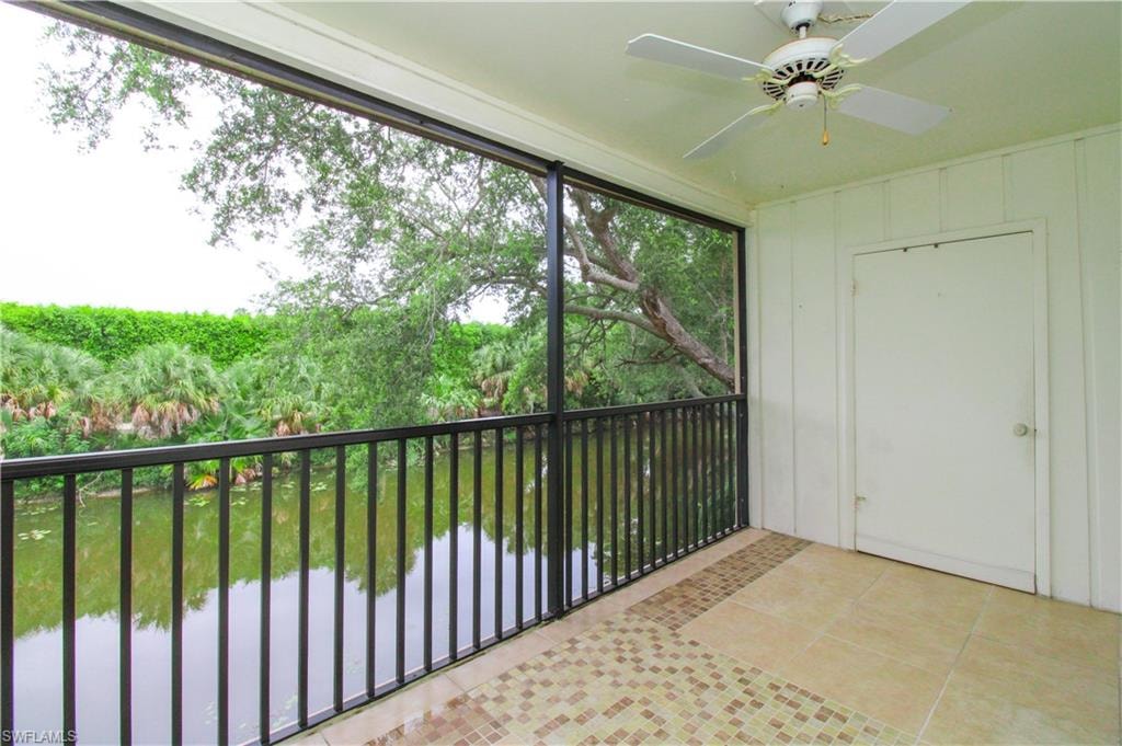 Unfurnished sunroom featuring ceiling fan
