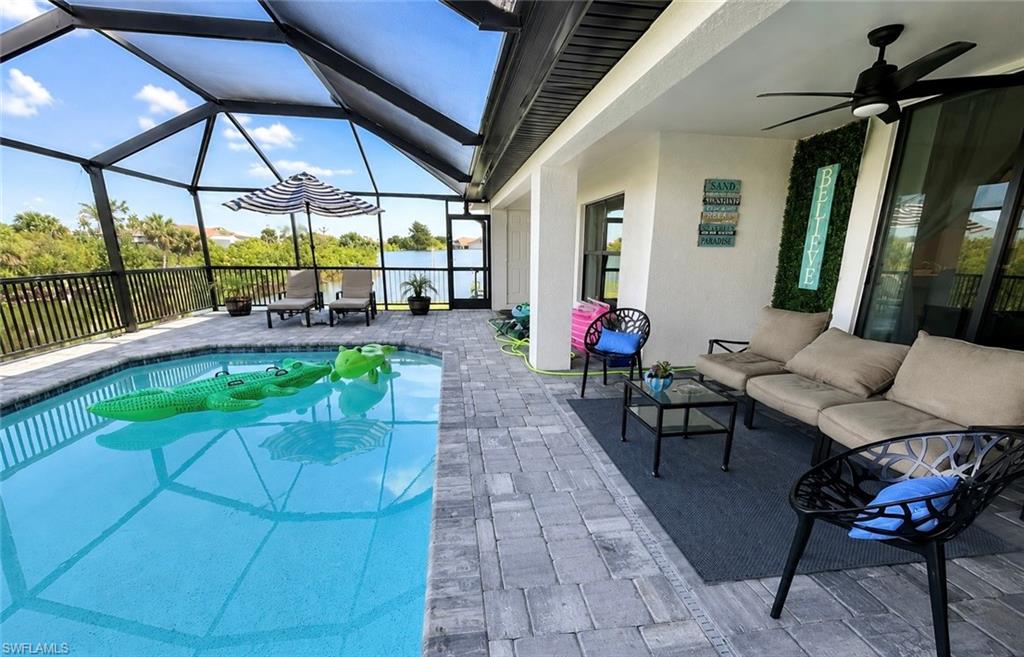 Expansive screened lanai with integrated saltwater pool featuring crystal-blue water and geometric tile decking