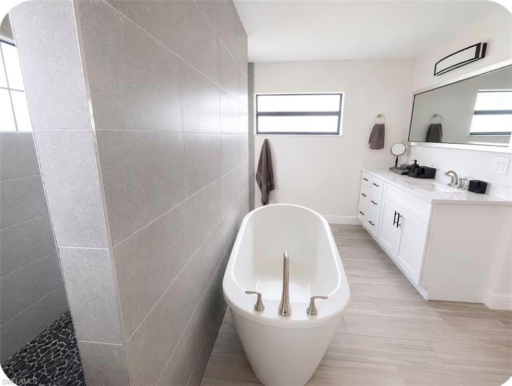 Freestanding soaking tub with brushed nickel fixtures