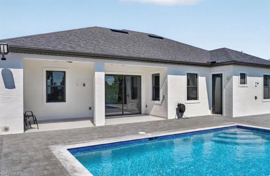 Rectangular swimming pool with integrated steps, surrounded by paver decking