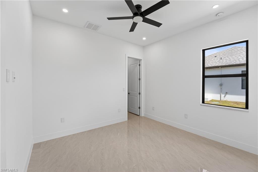 Neutral-toned tile flooring complements the white walls and trim
