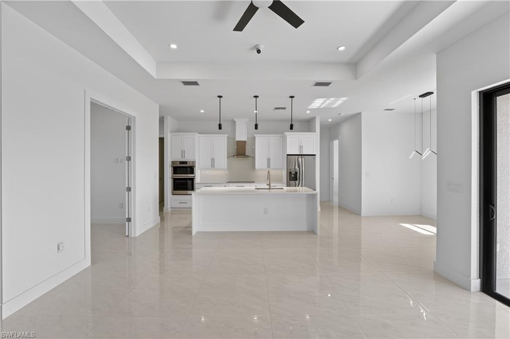 Open-concept interior featuring large format tile flooring throughout