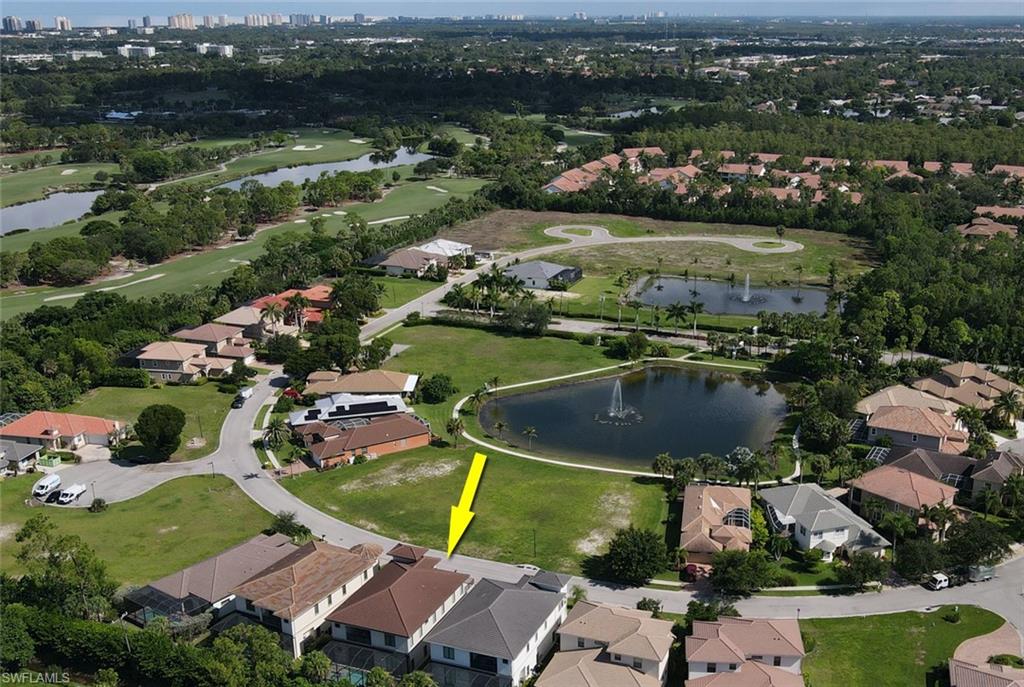 Birds eye view of property with a water view