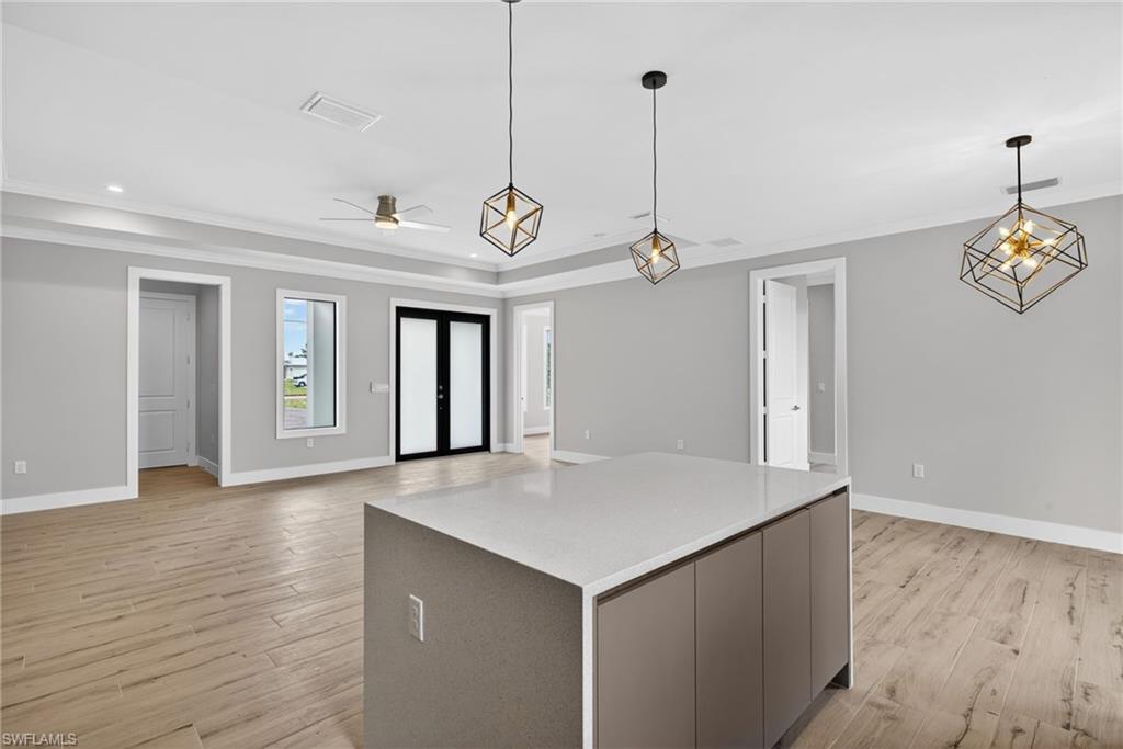 Kitchen island with a light-toned countertop and matte cabinetry