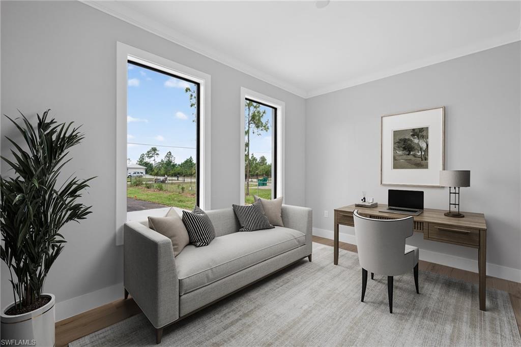 Bright interior with neutral wall finishes, crown molding, and wood-finish flooring