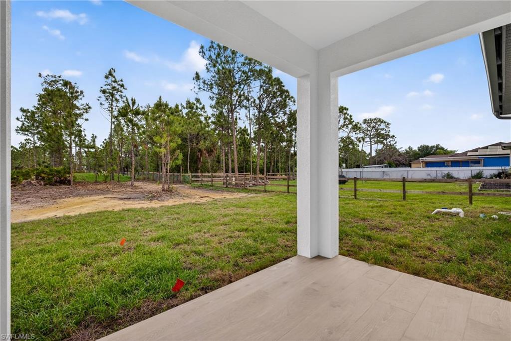 Covered patio with light-toned tile flooring