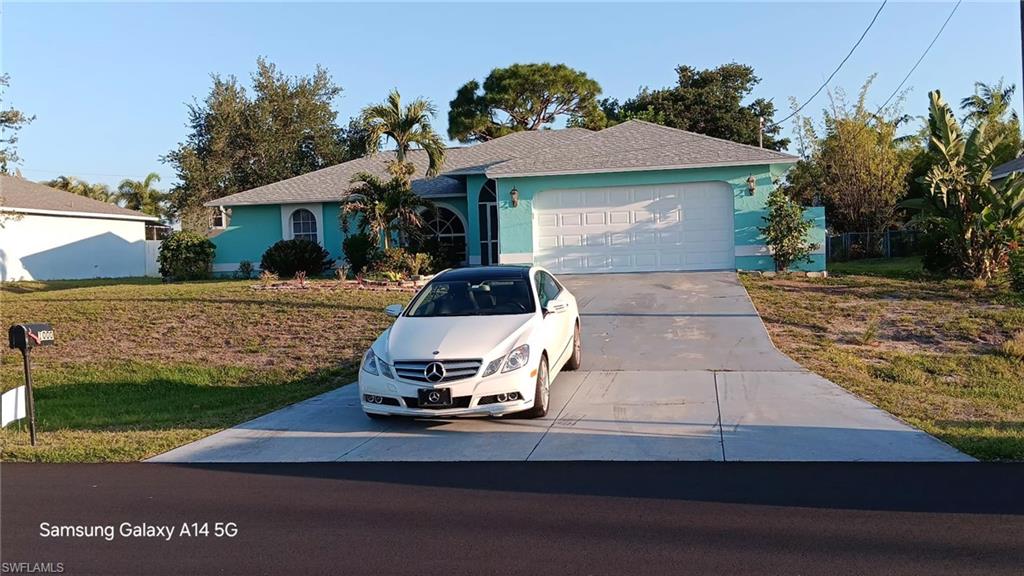Single-story residence featuring a two-car garage with a white panel door