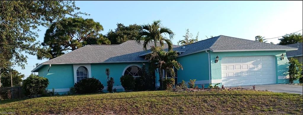 Single-story residence featuring a light blue exterior and a gray shingle roof