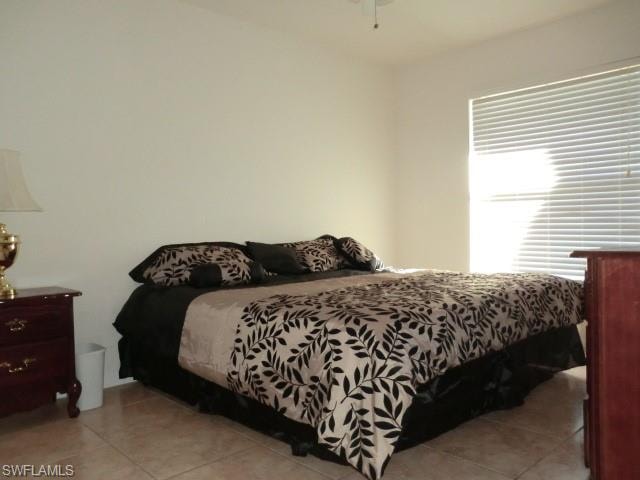 Bright room featuring tile flooring and a ceiling fan