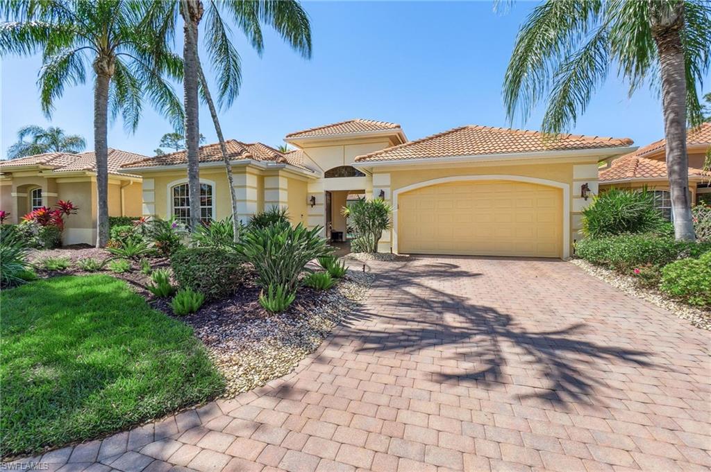 Mediterranean / spanish-style house featuring stucco siding, a tiled roof, an attached garage, and decorative driveway