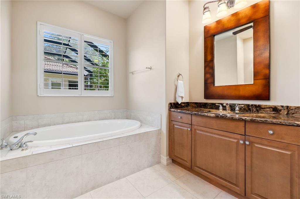 Full bathroom with tile patterned floors, a bath, and vanity