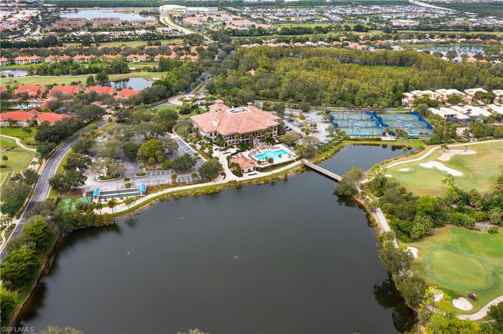 Birds eye view of property with view of golf course and a water view