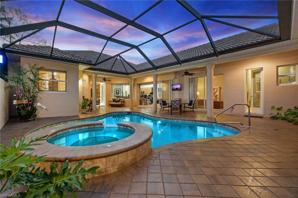 View of pool featuring a pool with connected hot tub, a ceiling fan, and a patio area