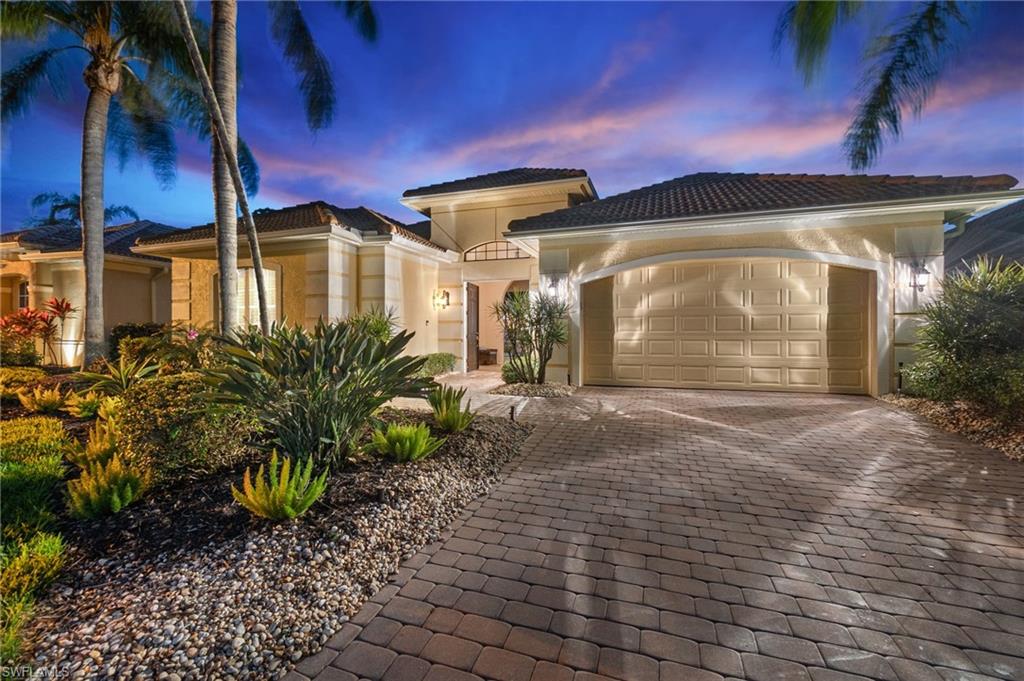 Mediterranean / spanish-style house with stucco siding, a tile roof, decorative driveway, and a garage