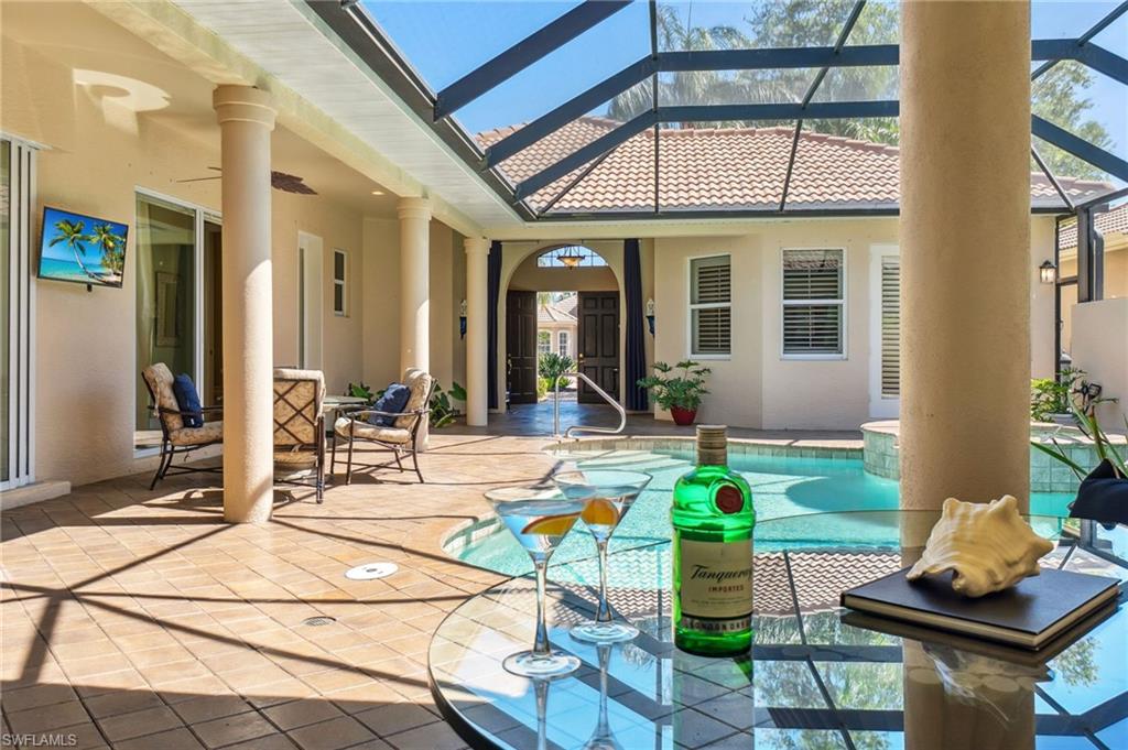 View of patio / terrace featuring a lanai, an outdoor pool, and ceiling fan