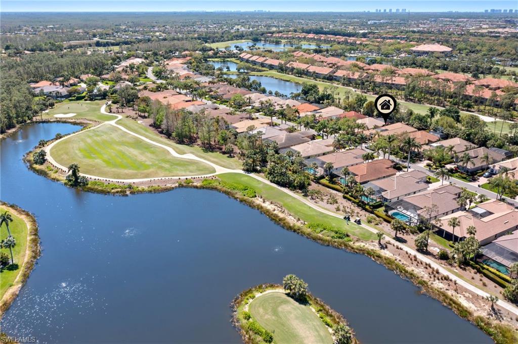 Aerial view featuring a residential view, golf course view, and a water view