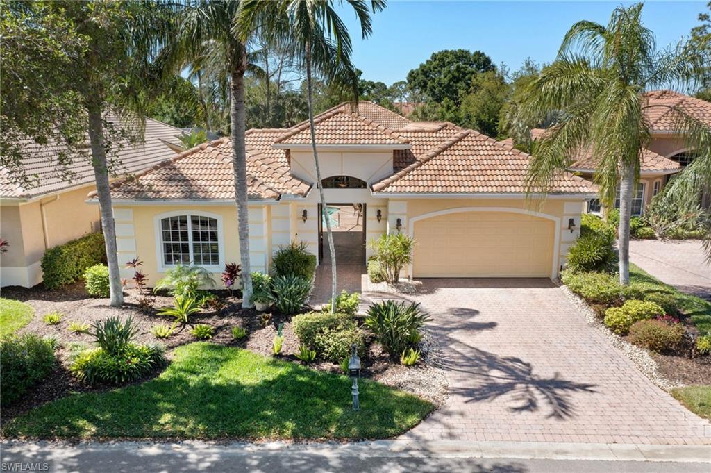 Mediterranean / spanish-style home featuring a tiled roof, an attached garage, driveway, and stucco siding