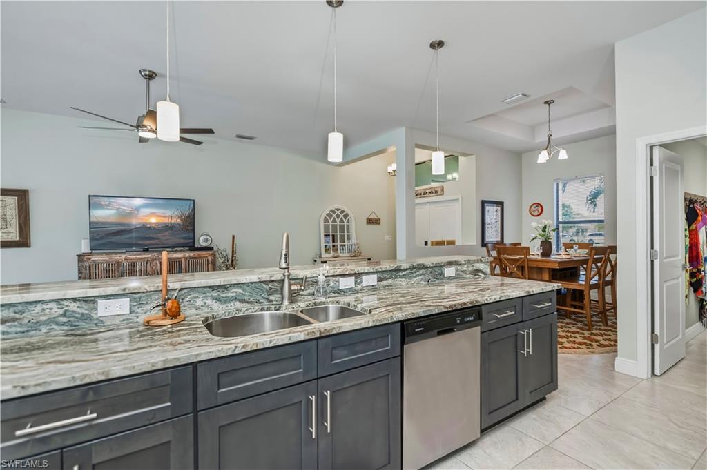 kitchen looking into dining area, great room, and front entry to home