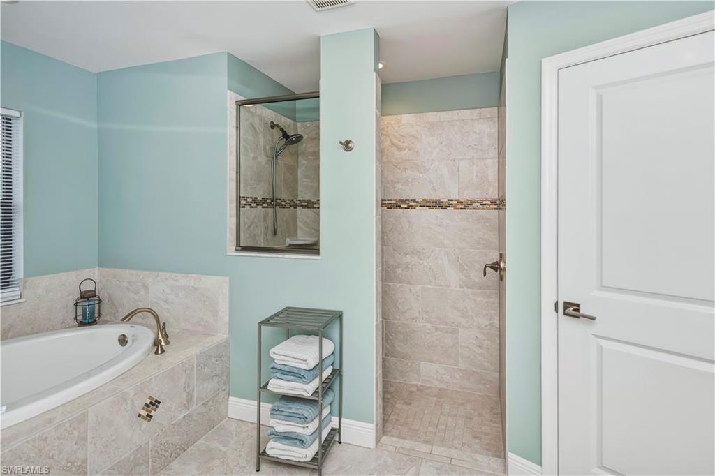 primary bathroom with soaking tub and shower